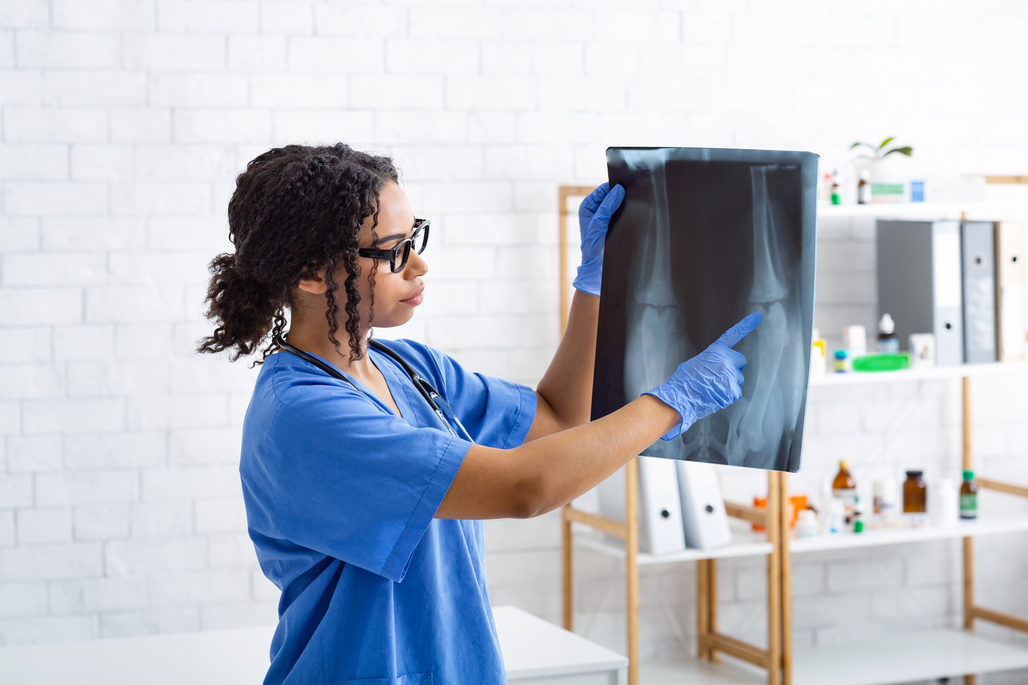 Female veterinary surgeon studying animal xray at modern clinic